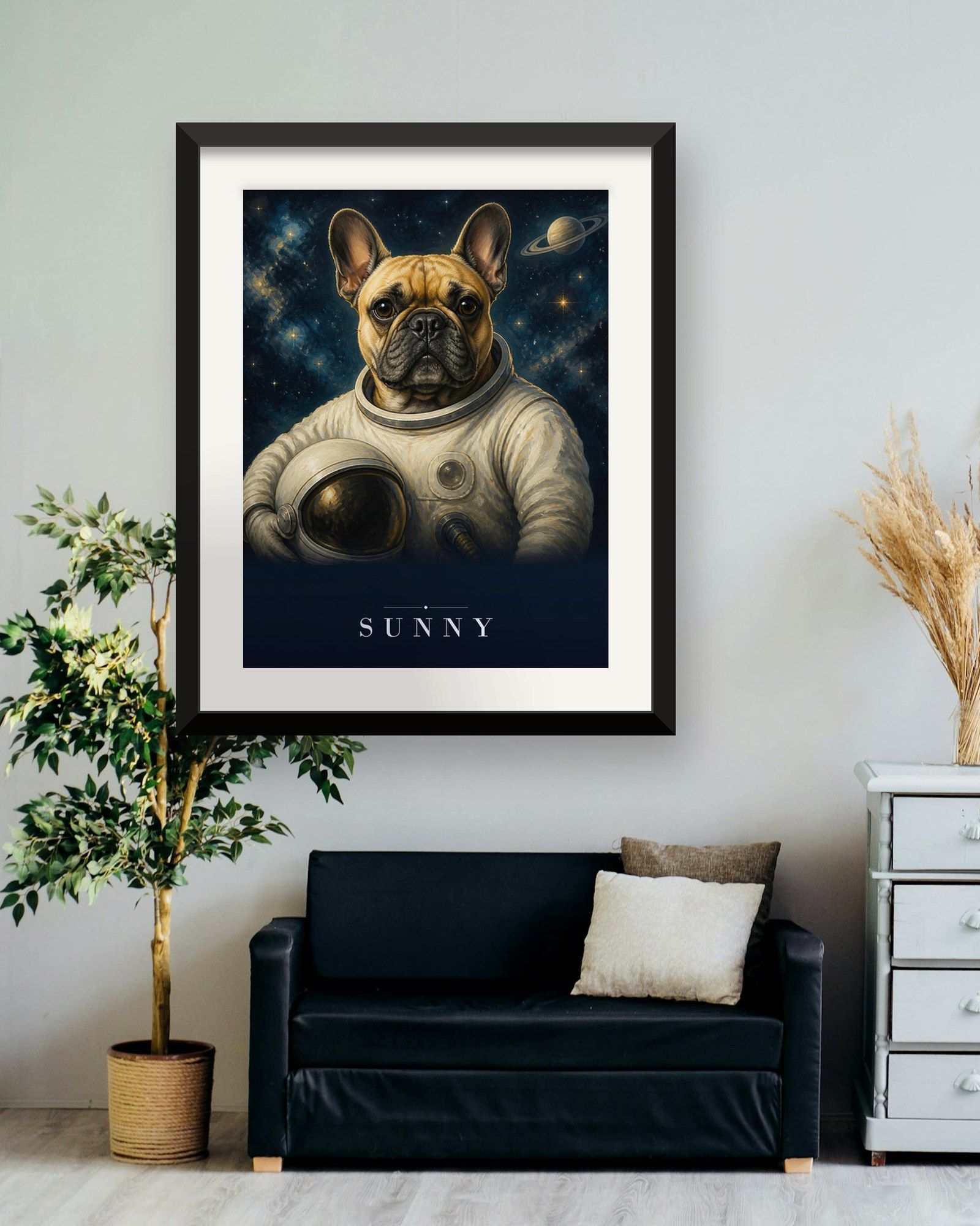 The printed portrait in a black frame above a dark sofa next to a white dresser (frame not included)