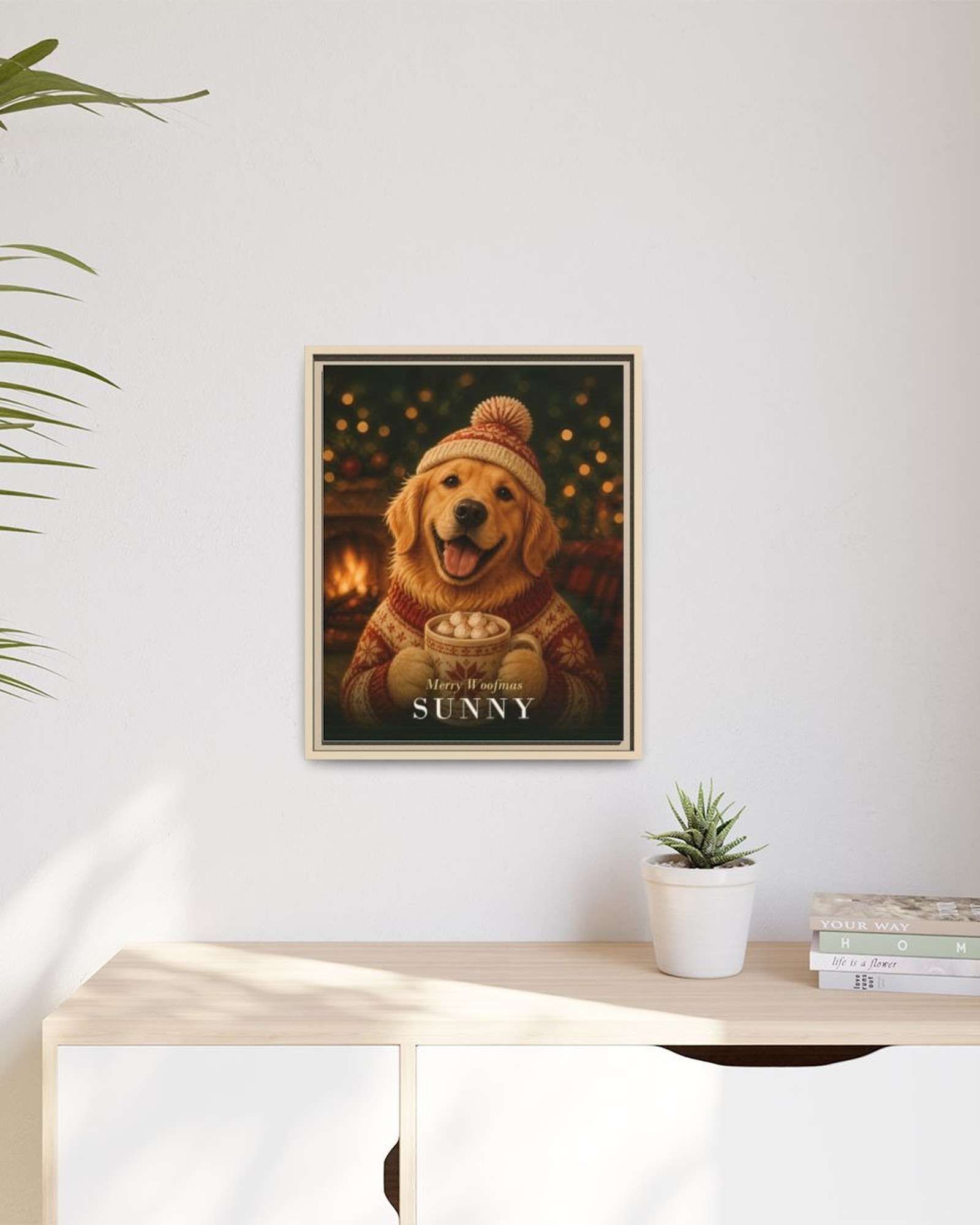 The framed Christmas portrait hanging above a light wooden sideboard