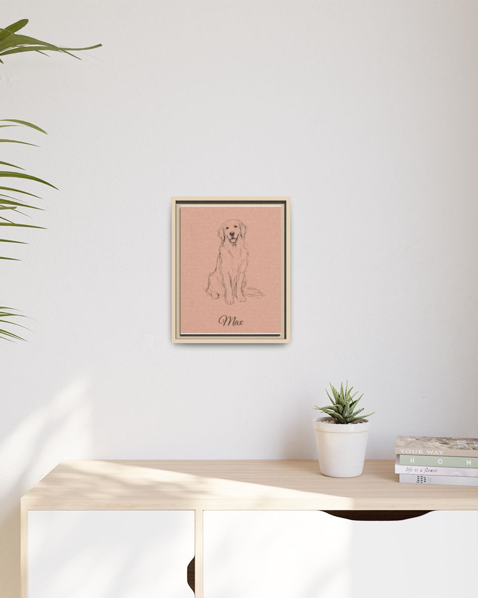 The framed portrait in a natural wood frame hanging above a light wooden sideboard