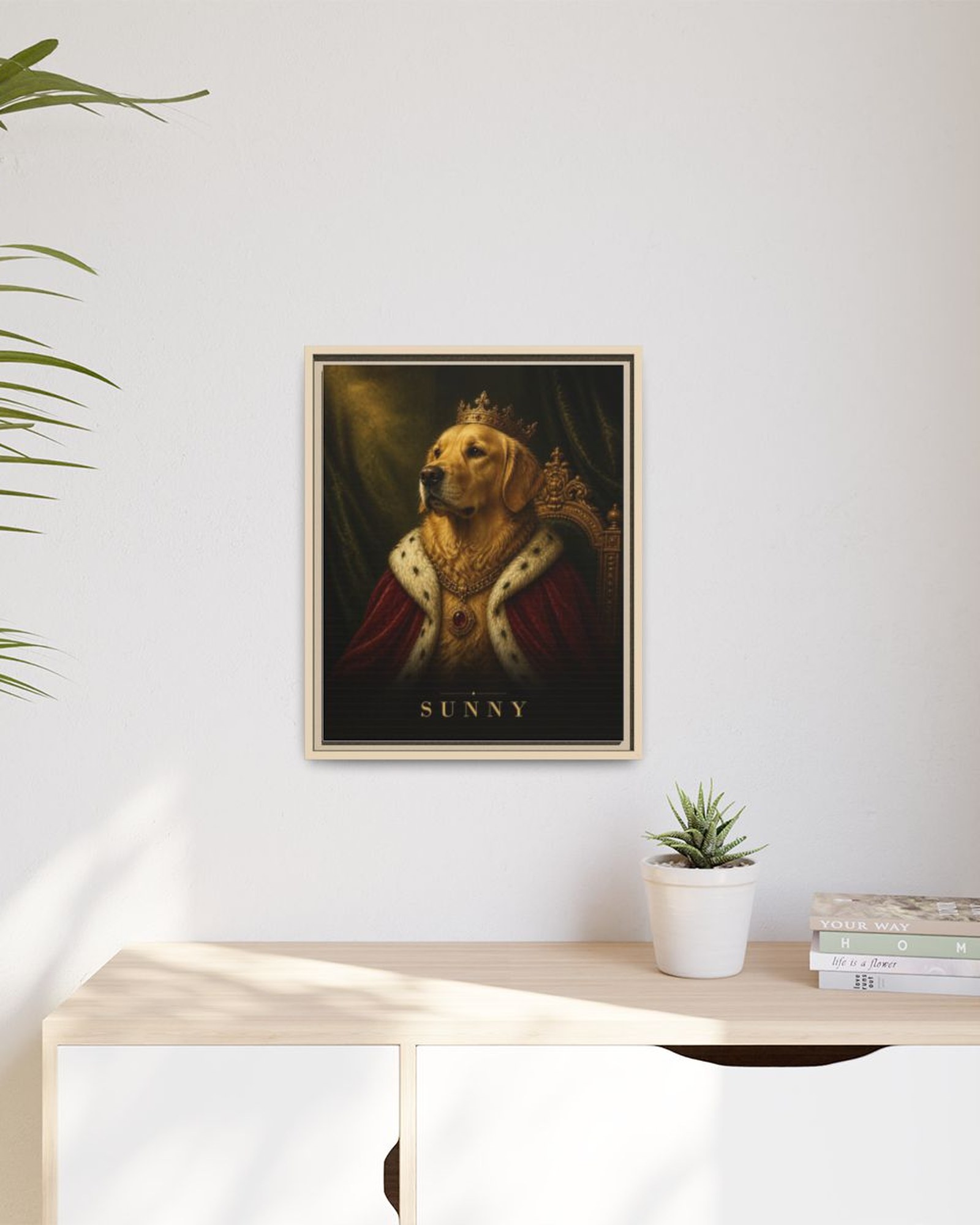 The framed portrait hanging above a light wooden sideboard