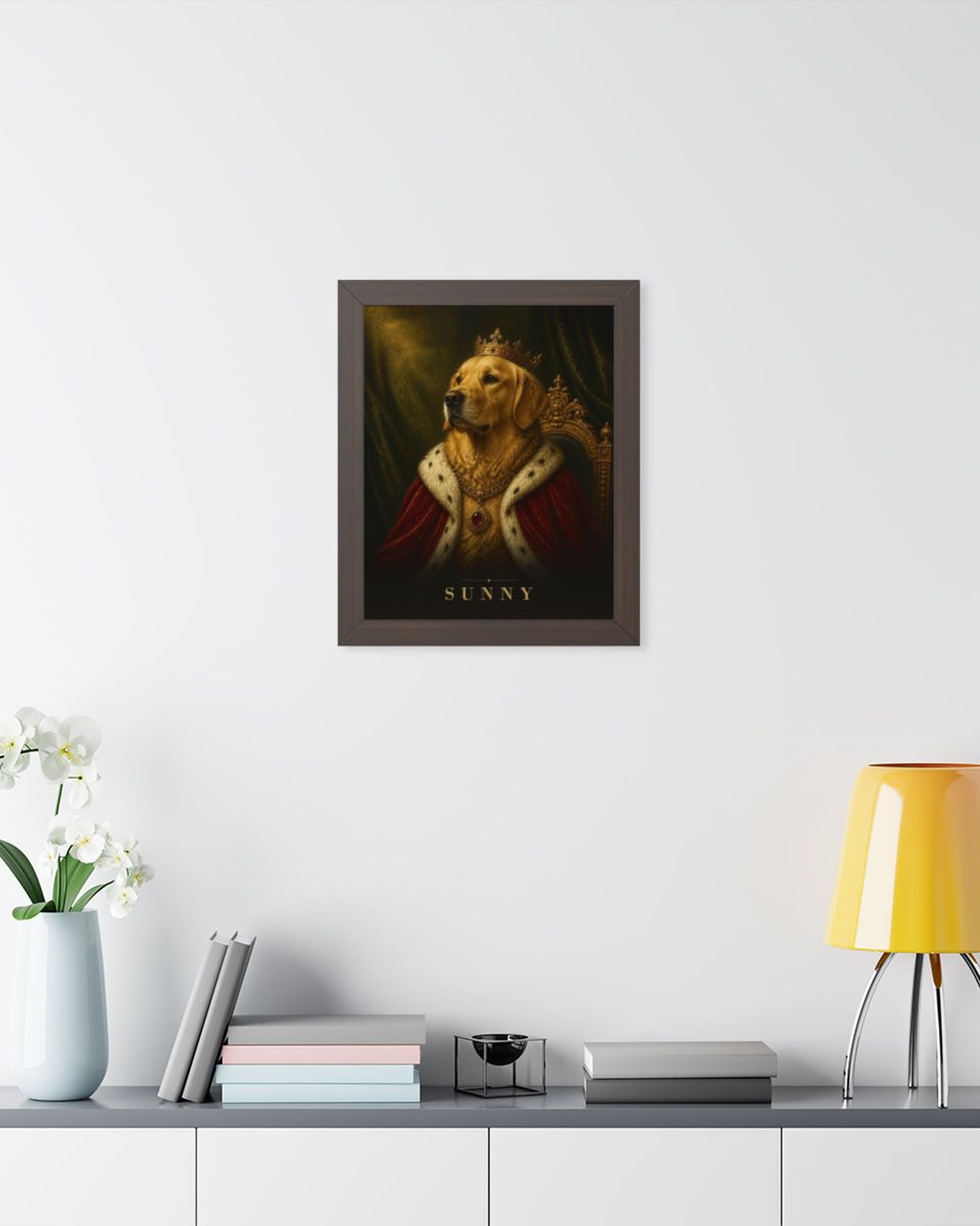 The walnut framed poster on a light gray wall above a white sideboard with plants